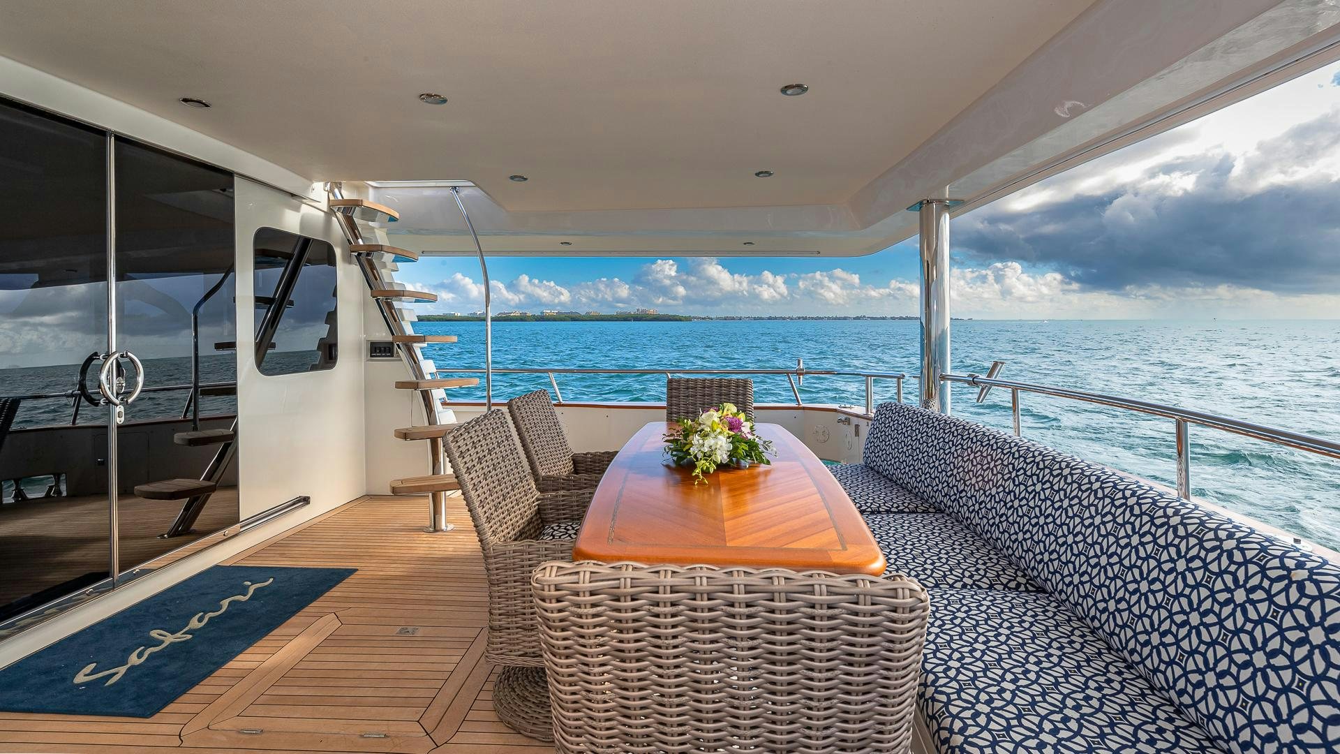 a balcony with a table and chairs aboard SAFARI Yacht for Sale