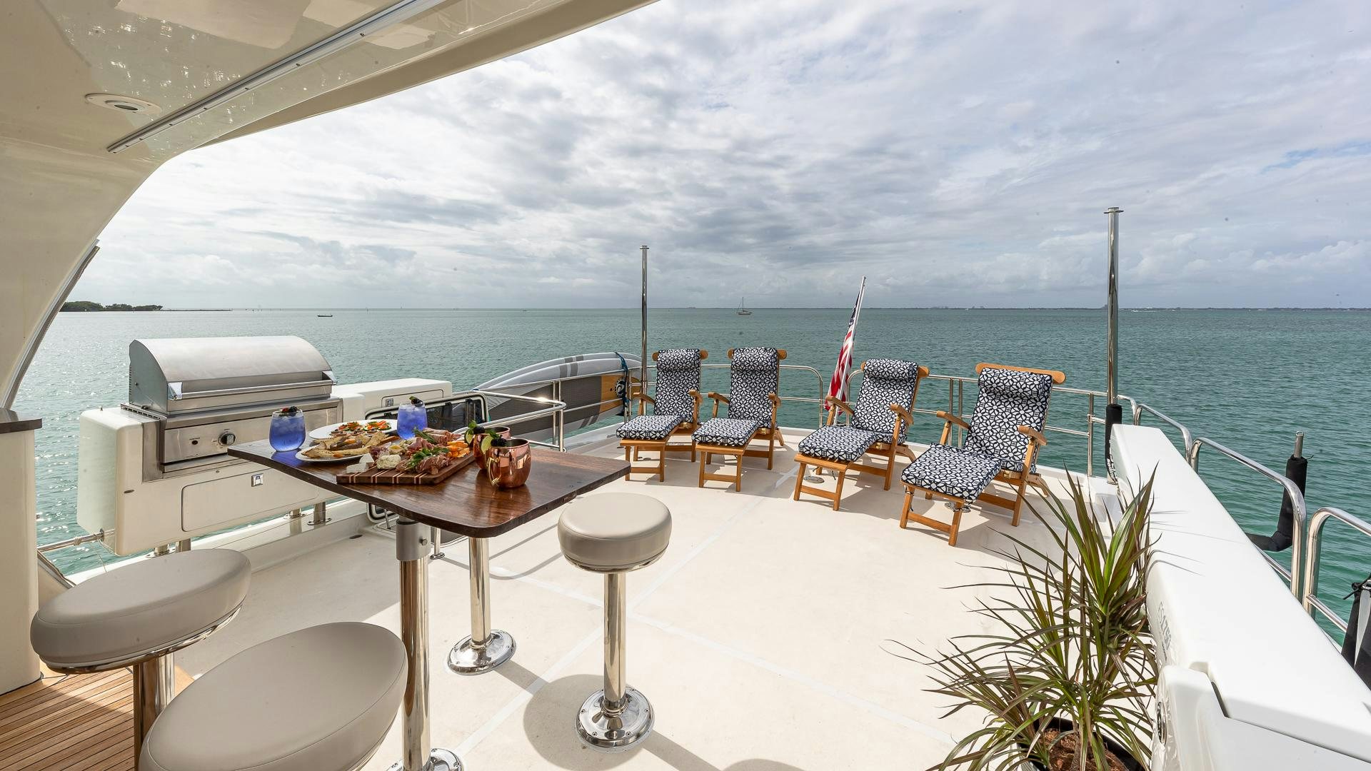 a room with a table and chairs on a balcony overlooking the ocean aboard SAFARI Yacht for Sale