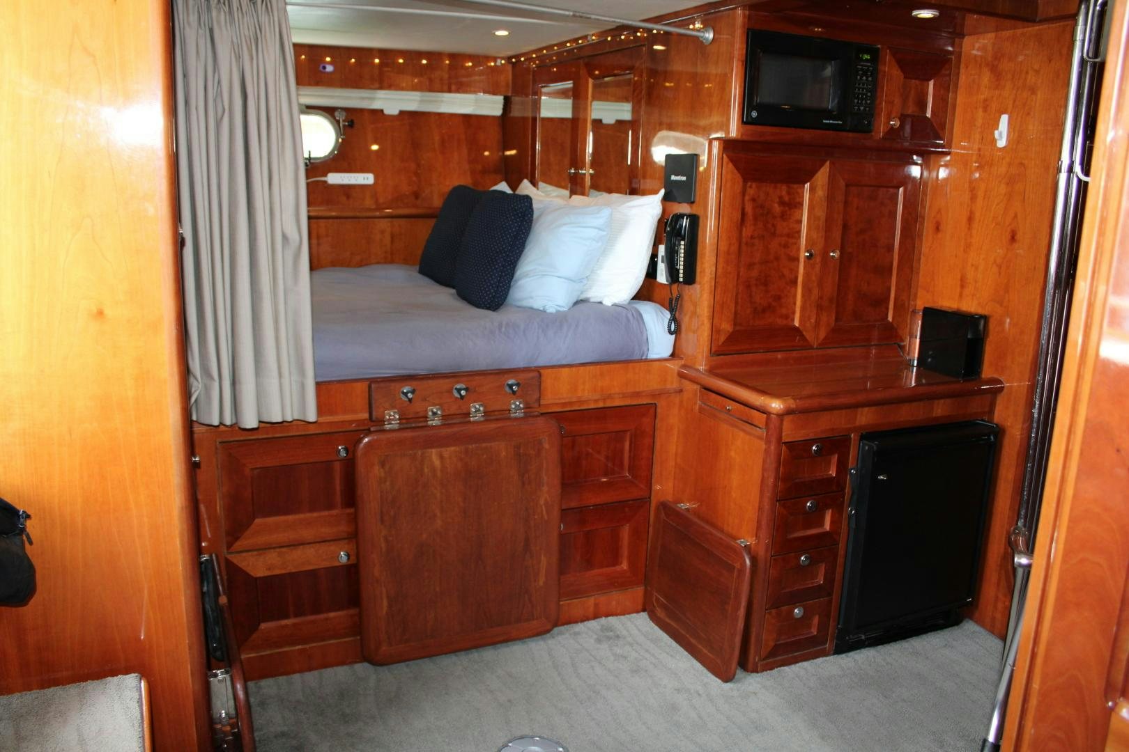 a bedroom with a bed and a desk aboard SAFARI Yacht for Sale