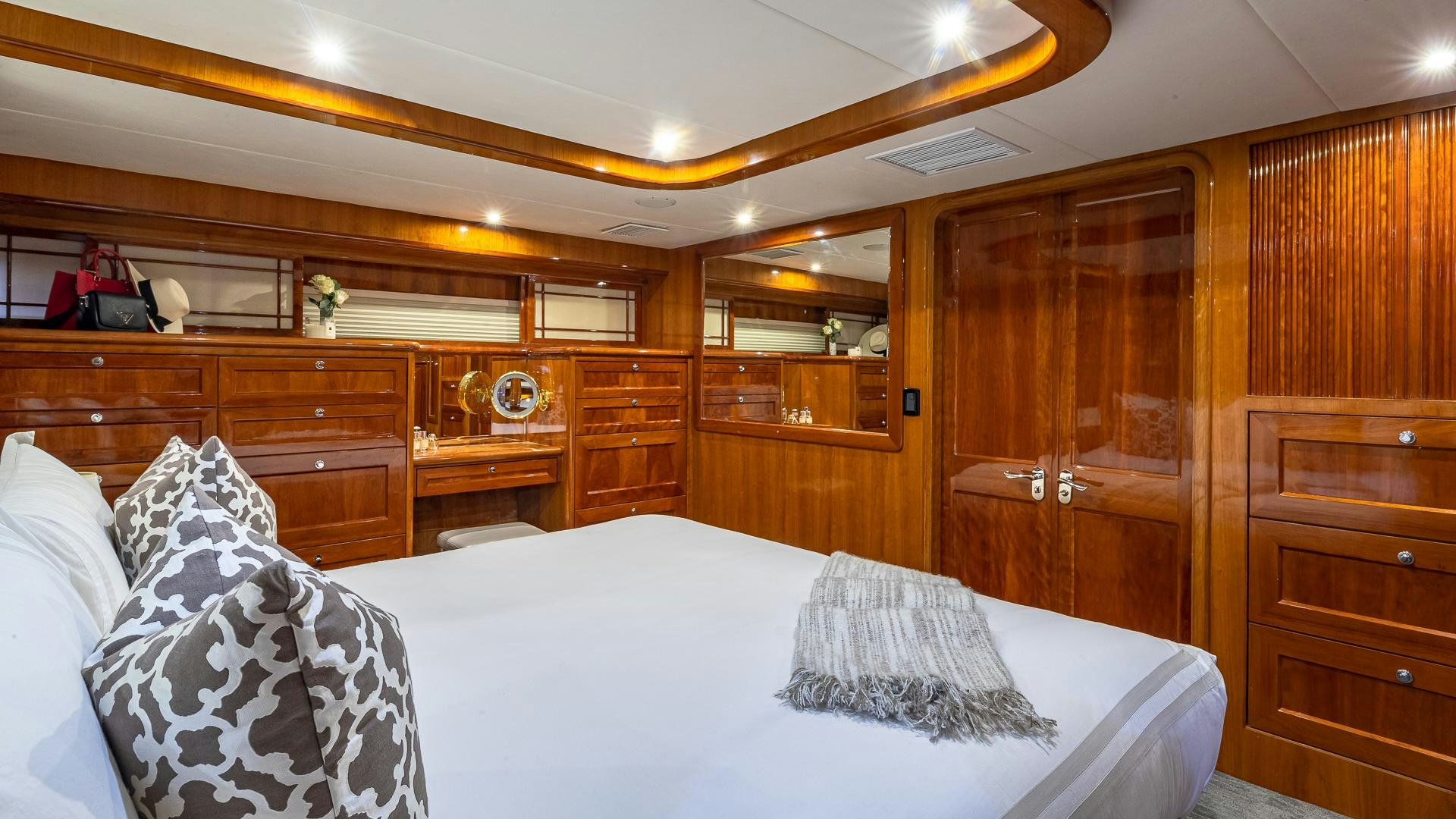 a bed with white sheets and pillows aboard SAFARI Yacht for Sale