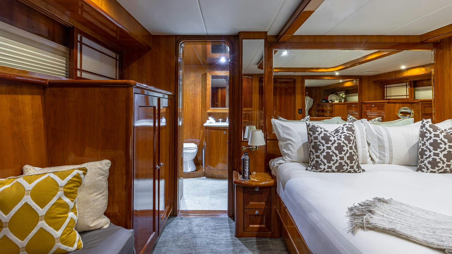 a room with a bed and a mirror aboard SAFARI Yacht for Sale