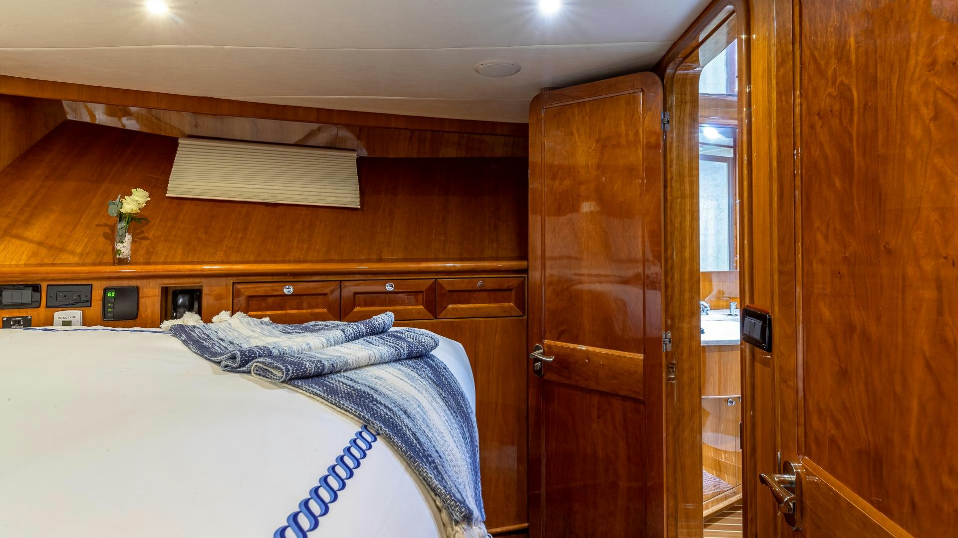 a room with a bed and a wood door aboard SAFARI Yacht for Sale