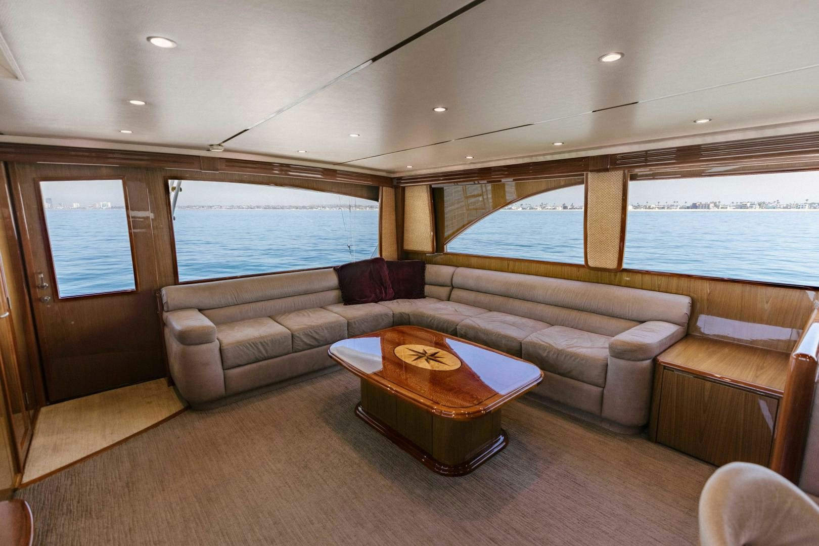 a living room with a couch and a large window aboard SALTY K Yacht for Sale