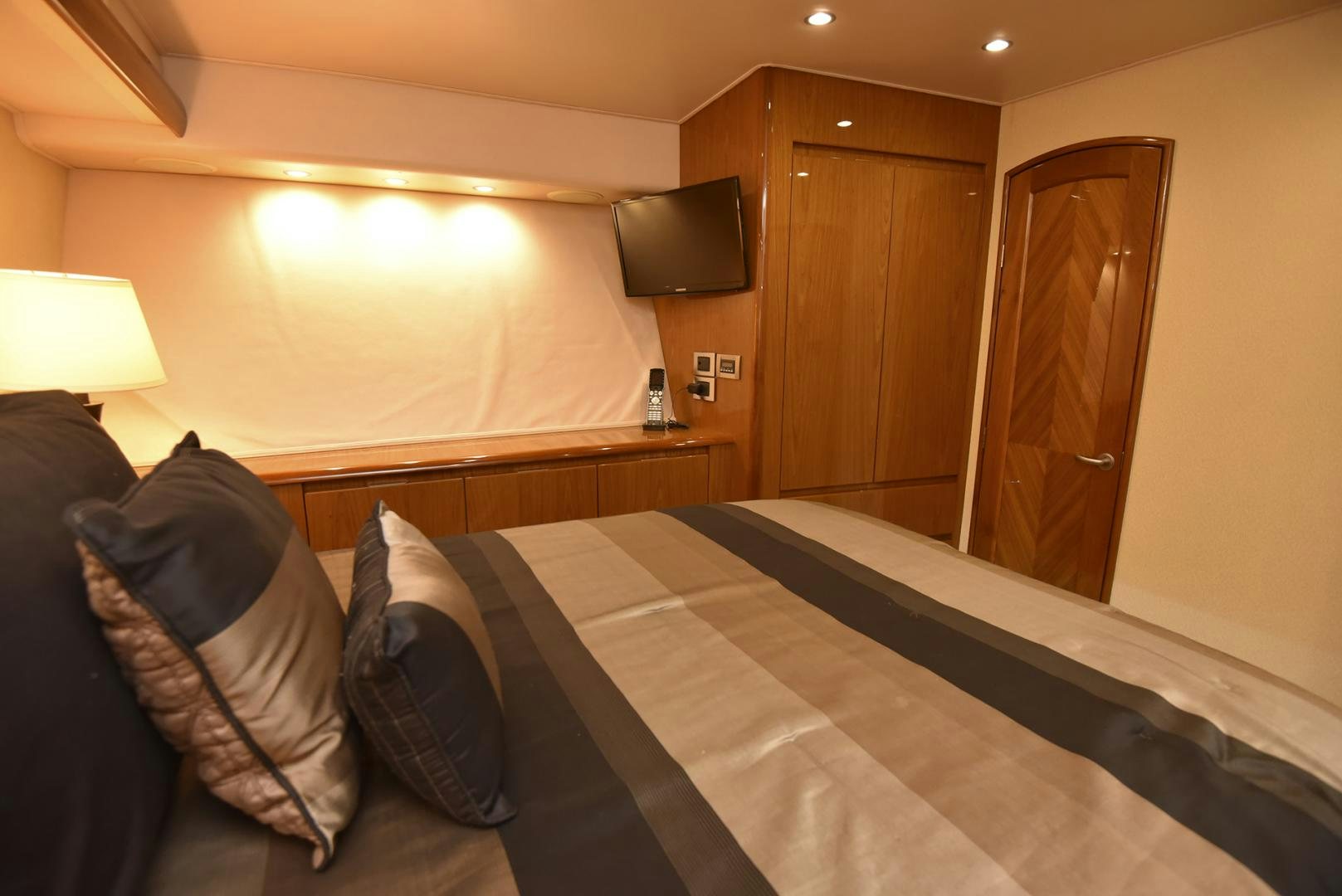 a hotel room with a bed and tv aboard SALTY K Yacht for Sale