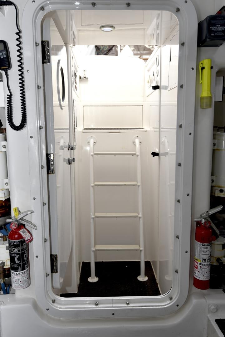 a white cabinet with doors aboard SALTY K Yacht for Sale