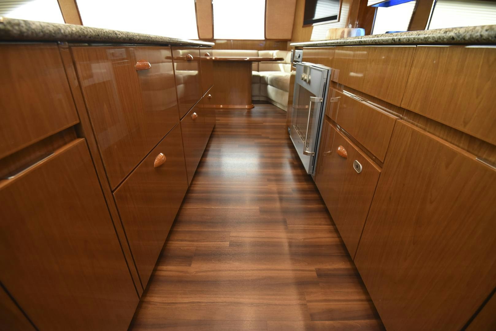 a kitchen with wooden cabinets aboard SALTY K Yacht for Sale