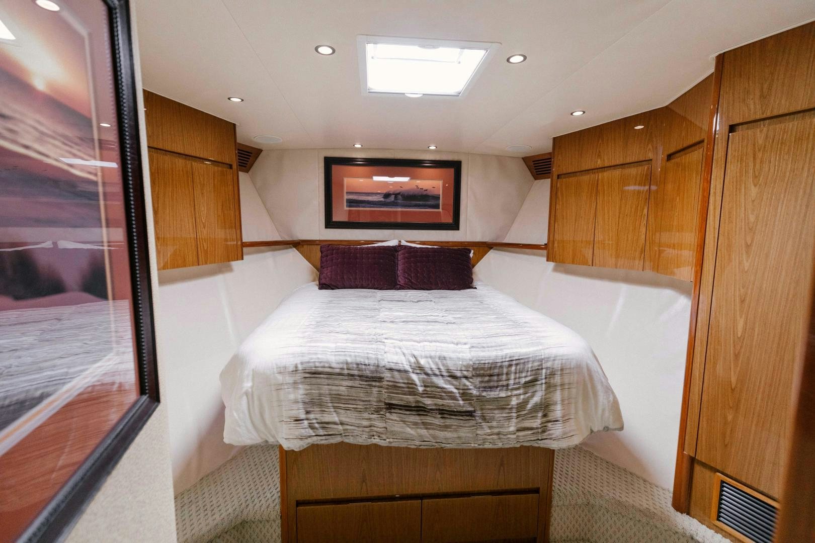 a bedroom with a bed and a mirror aboard SALTY K Yacht for Sale