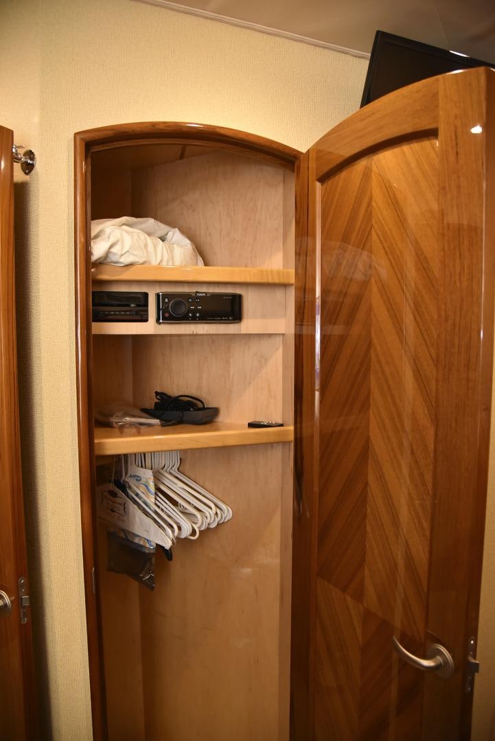 a closet with clothes and a phone aboard SALTY K Yacht for Sale