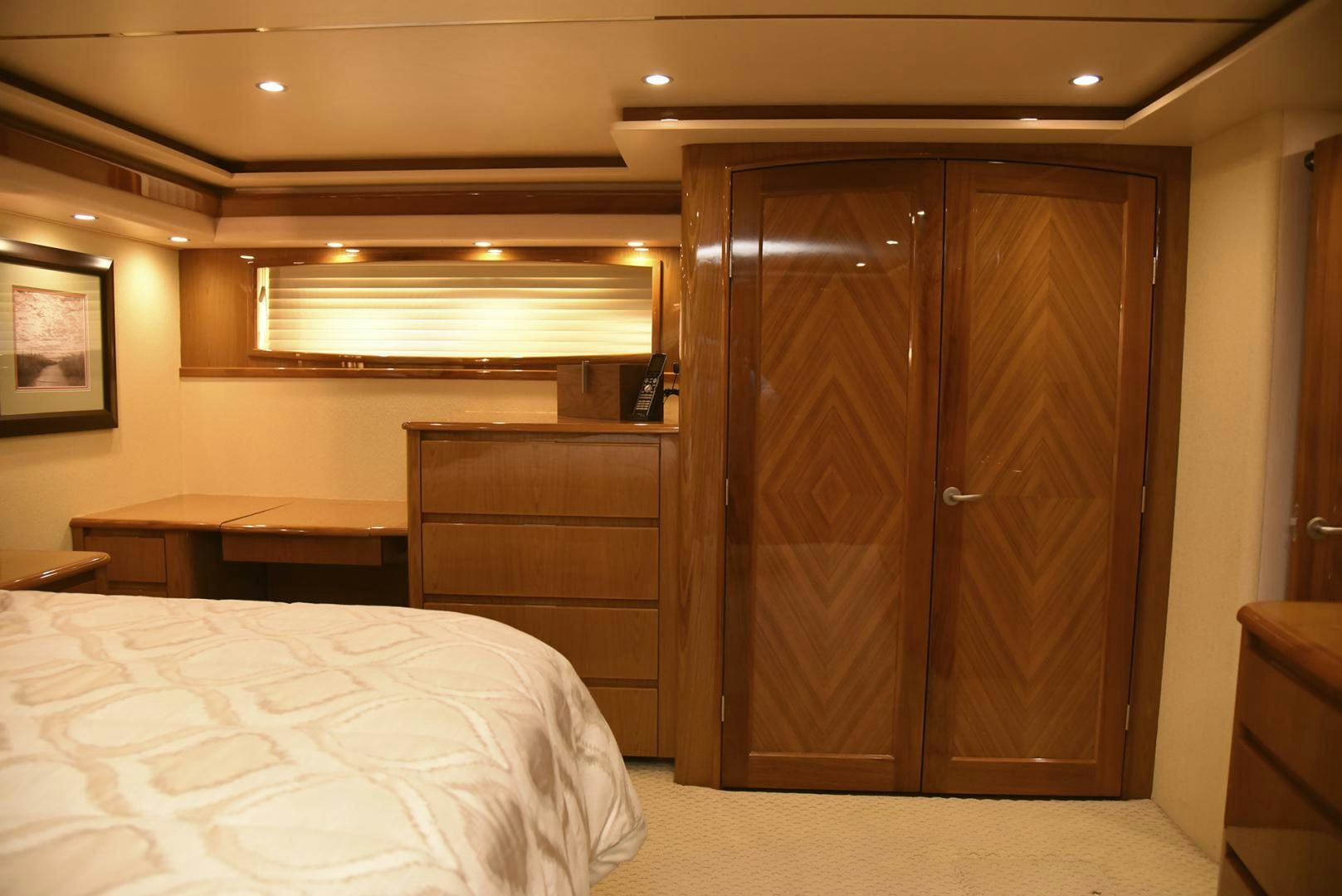 a bedroom with a closet and a bed aboard SALTY K Yacht for Sale