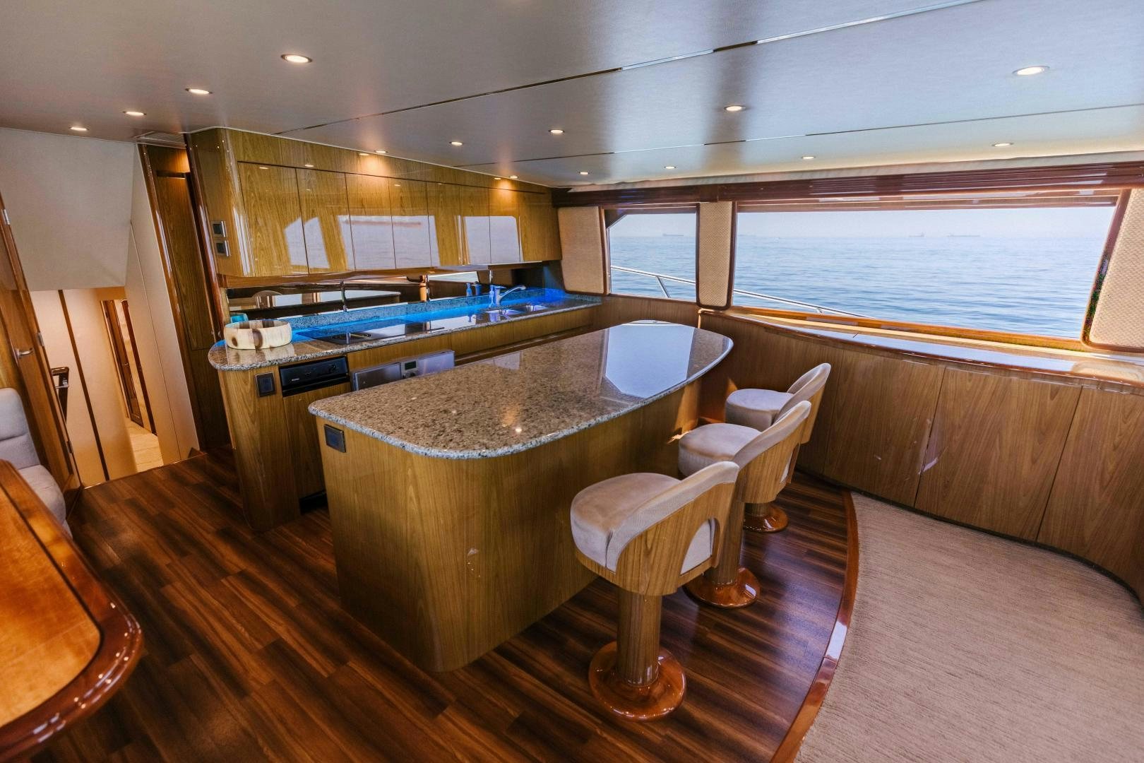 a large kitchen with a bar and chairs aboard SALTY K Yacht for Sale