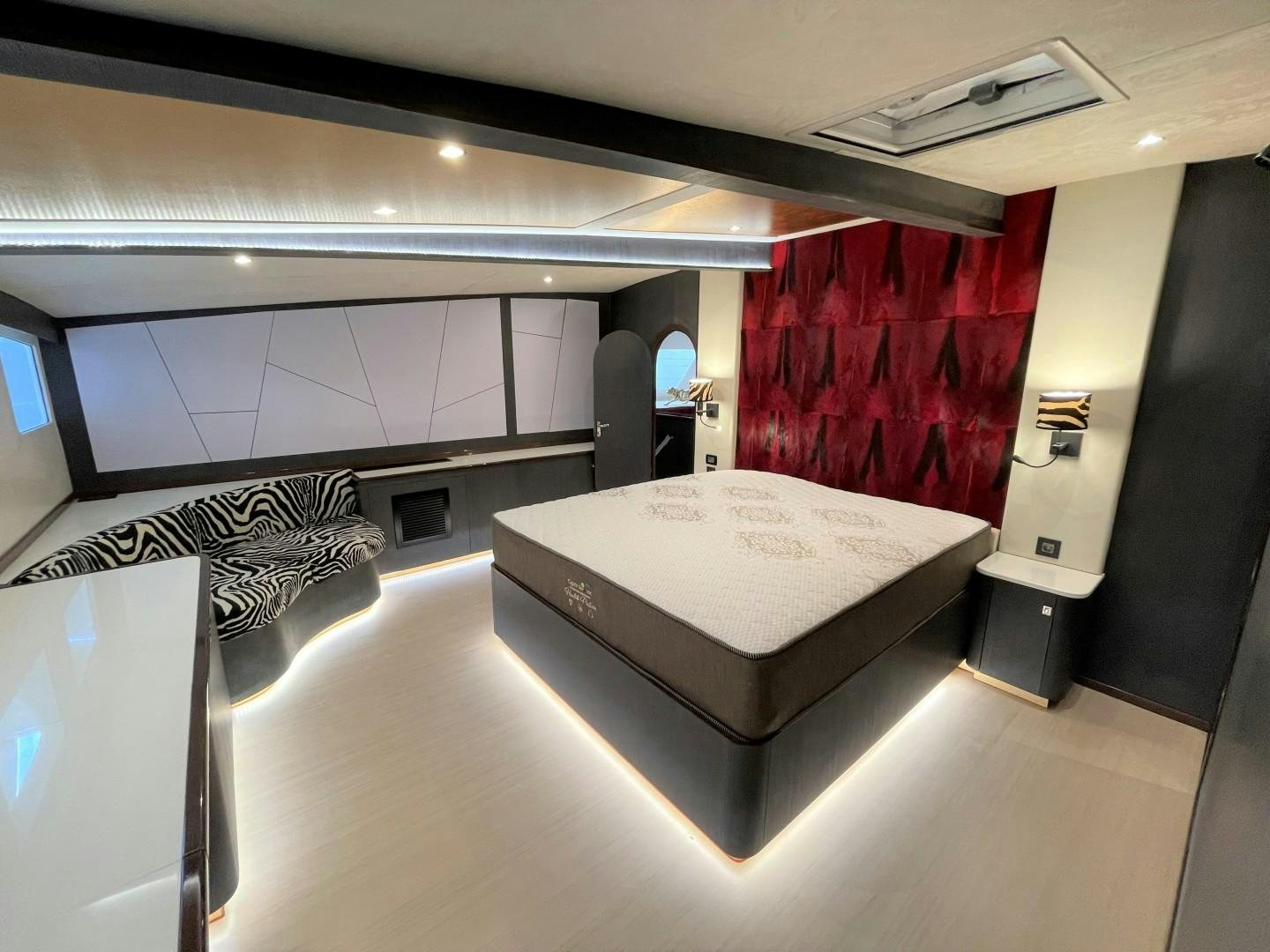 a room with a bed and a red curtain aboard SKYE Yacht for Sale