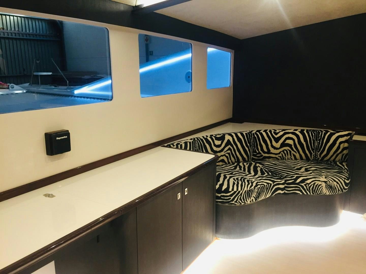 a room with a couch and a tv on the wall aboard SKYE Yacht for Sale
