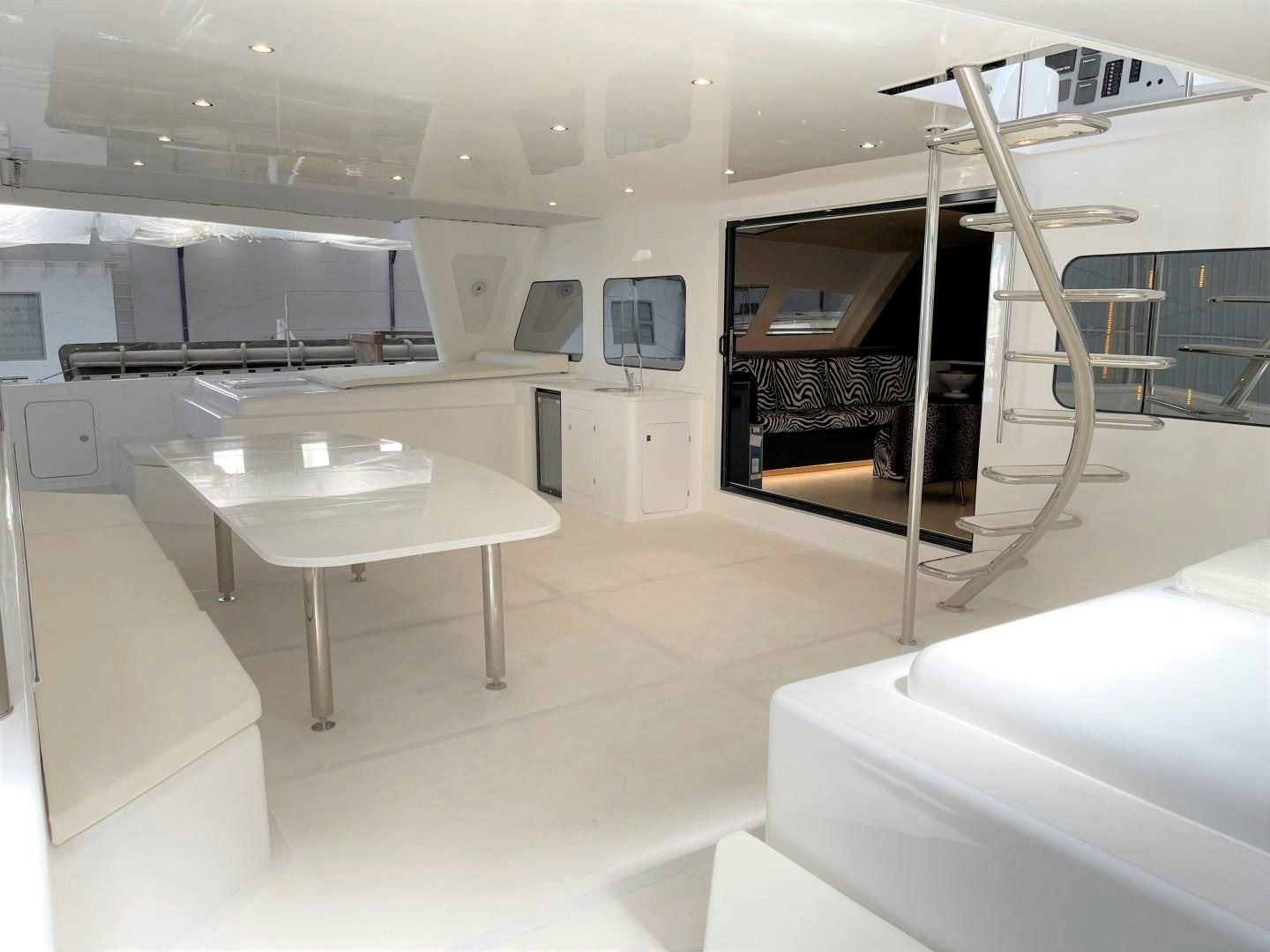 a room with a table and chairs aboard SKYE Yacht for Sale