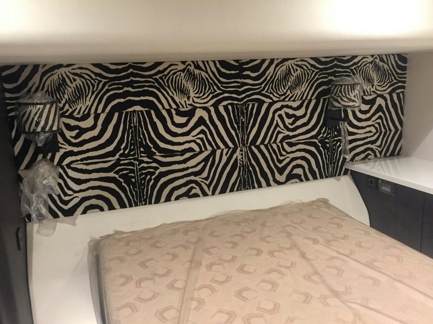 a bed with a white sheet aboard SKYE Yacht for Sale