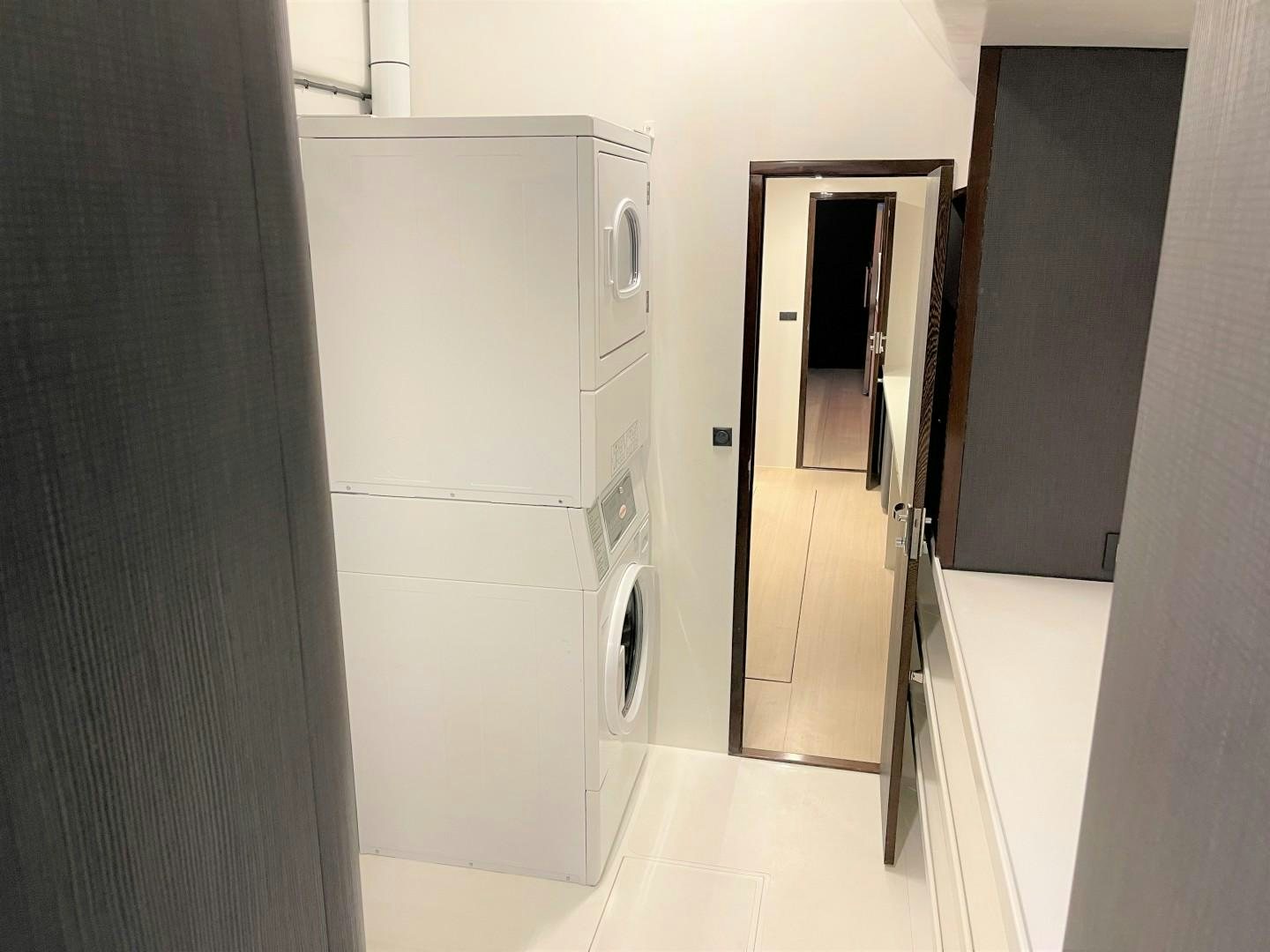 a room with a washing machine and cabinets aboard SKYE Yacht for Sale