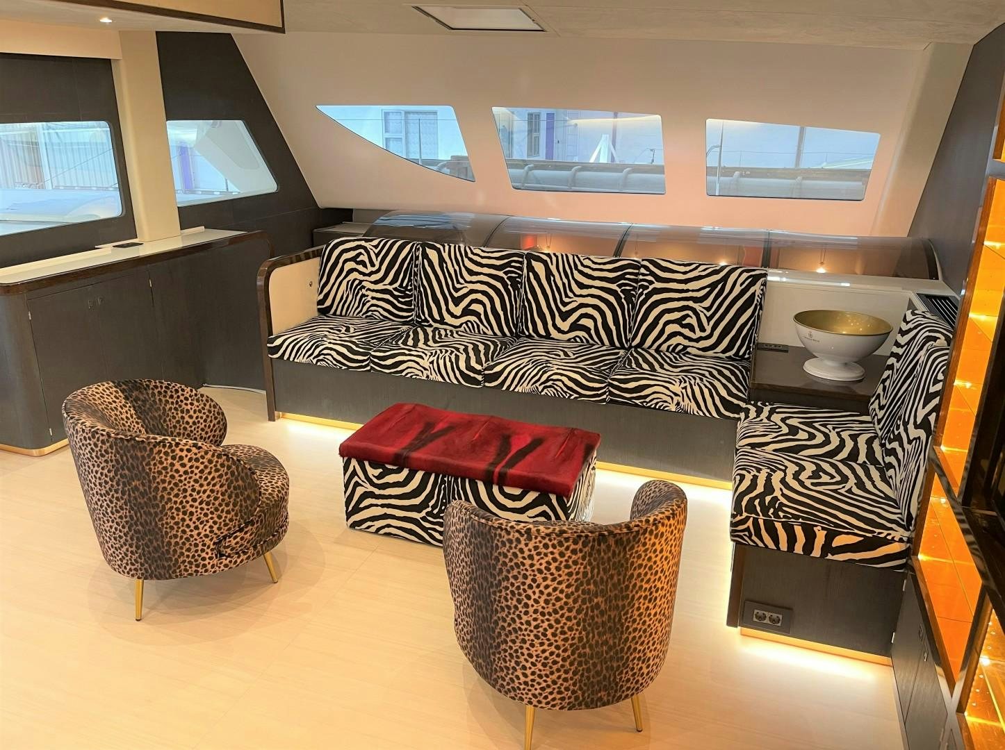 a room with a couch and a table with chairs aboard SKYE Yacht for Sale