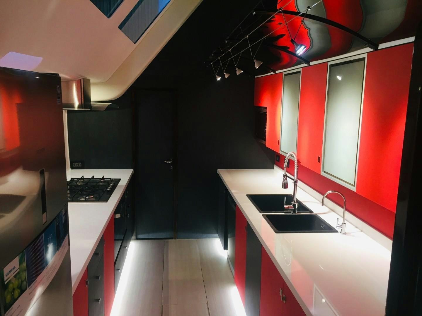 a kitchen with red cabinets aboard SKYE Yacht for Sale