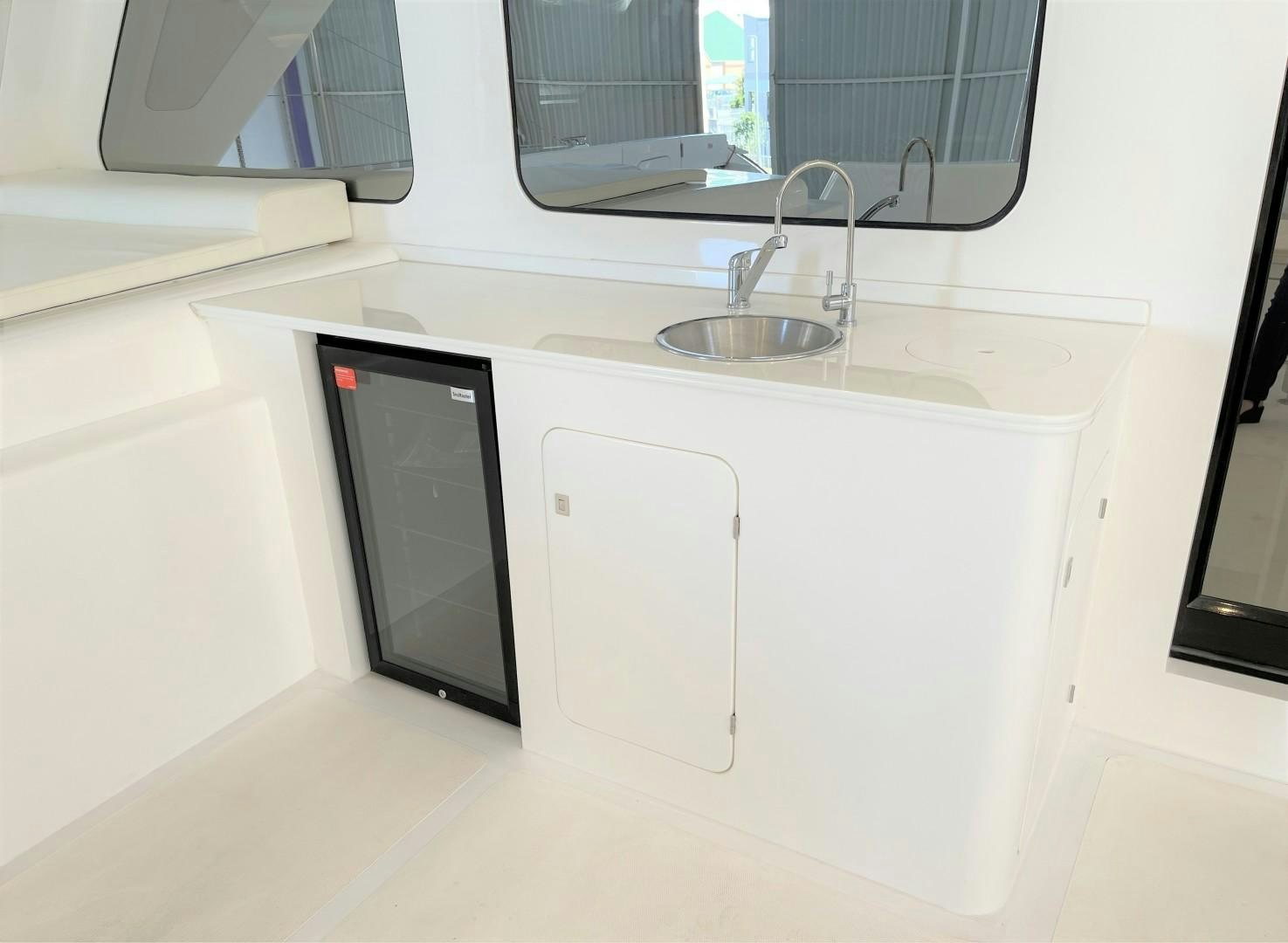 a sink and microwave in a kitchen aboard SKYE Yacht for Sale