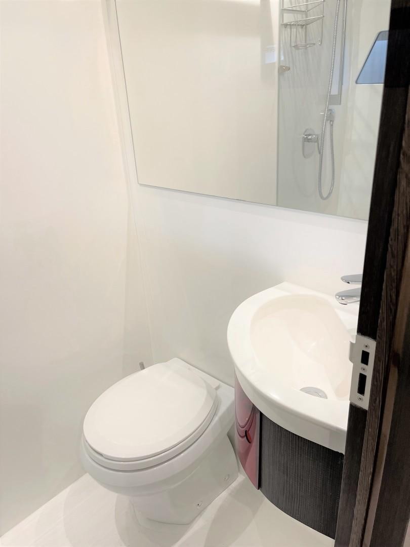 a bathroom with a sink toilet and a mirror aboard SKYE Yacht for Sale
