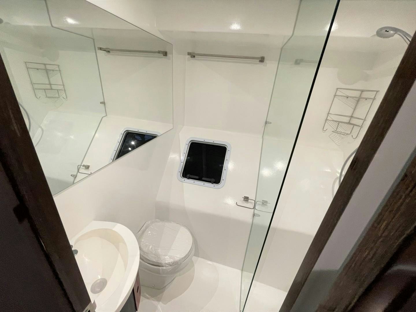 a bathroom with a small window aboard SKYE Yacht for Sale