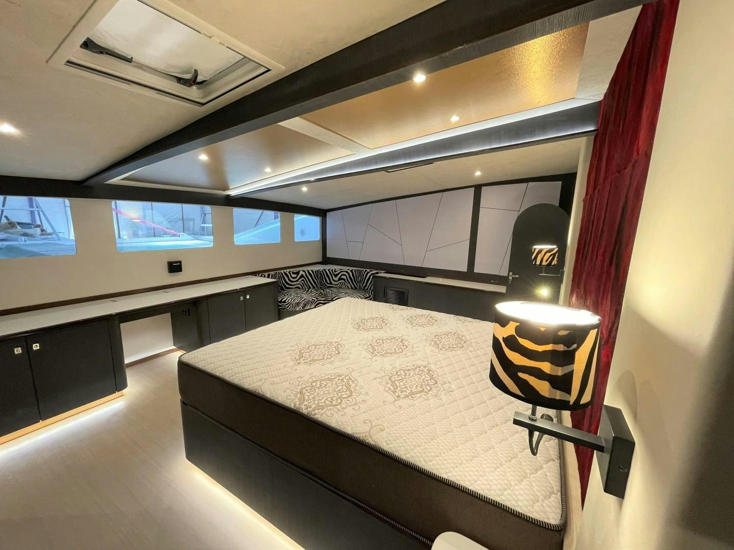 a room with a bed and a table aboard SKYE Yacht for Sale
