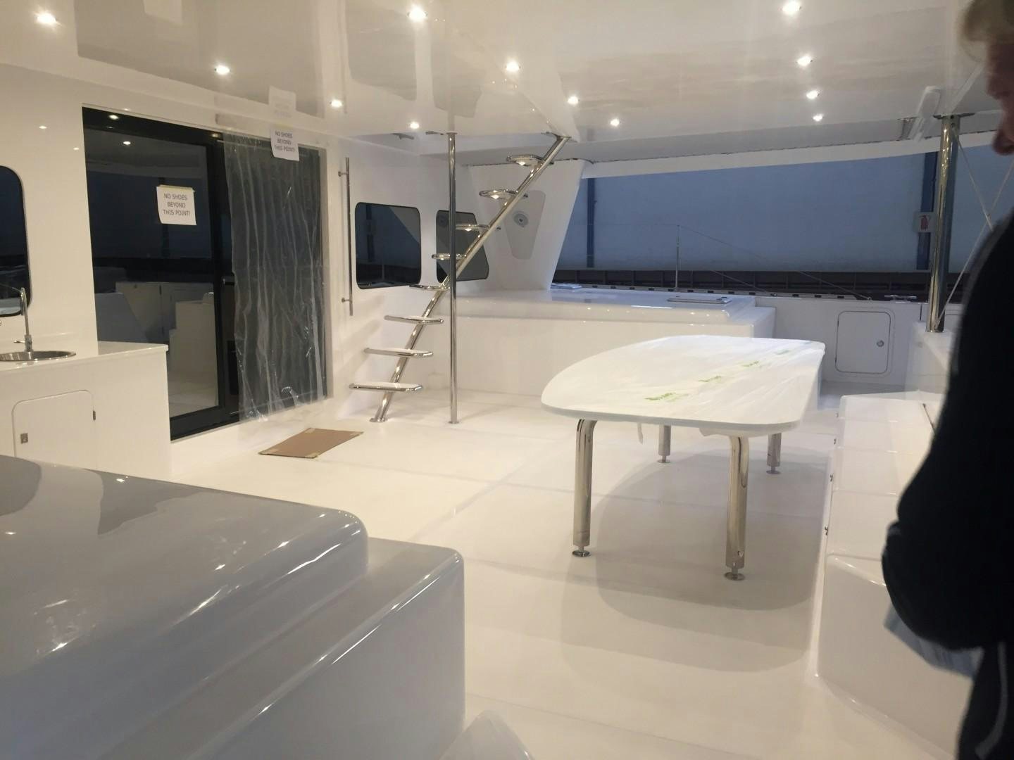 a person standing in a room with a table and chairs aboard SKYE Yacht for Sale