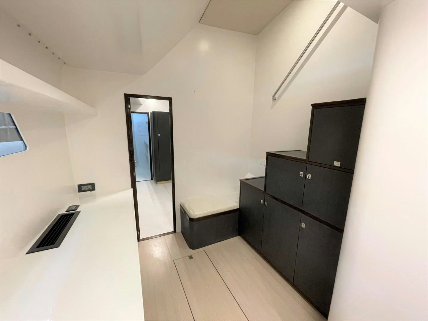 a room with a wood floor and a black cabinet with a black cabinet and a black cabinet with aboard SKYE Yacht for Sale