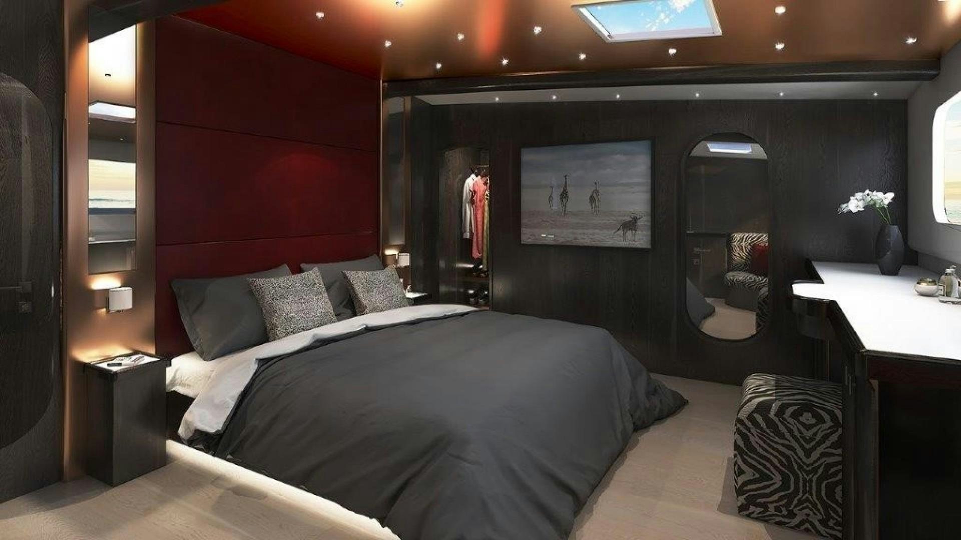 a bed with a black headboard aboard SKYE Yacht for Sale