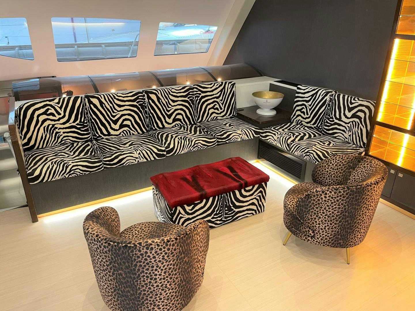 a couch with a rug and cups on it aboard SKYE Yacht for Sale