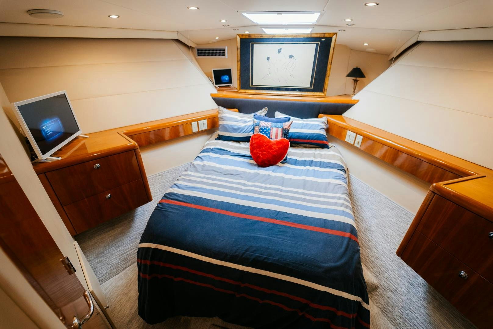 a bedroom with a bed and a television aboard Haggis XV Yacht for Sale
