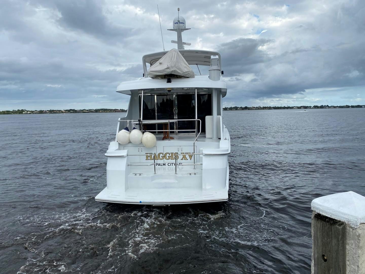 a small white boat in the water aboard Haggis XV Yacht for Sale