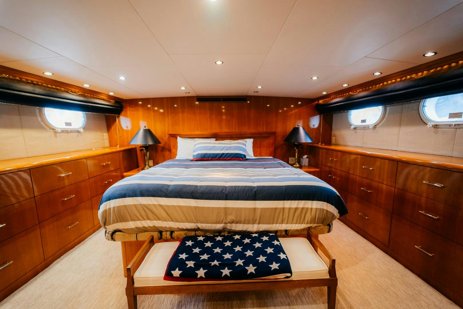 a bedroom with a bed and a dresser aboard Haggis XV Yacht for Sale