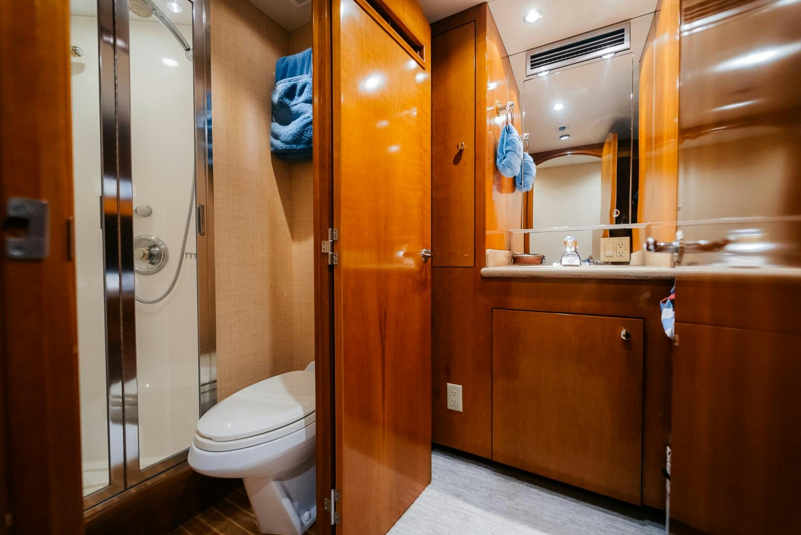 a bathroom with wooden cabinets aboard Haggis XV Yacht for Sale