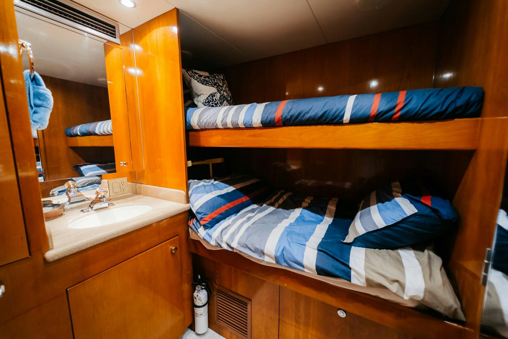 a bunk bed with a sink and a mirror aboard Haggis XV Yacht for Sale