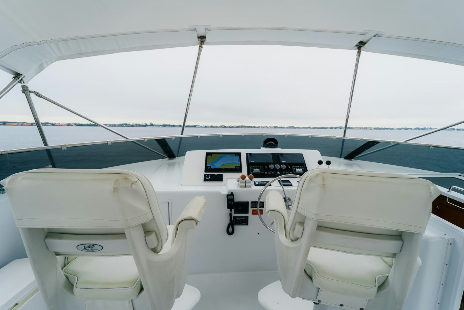 a boat with a seat and a chair on the deck aboard Haggis XV Yacht for Sale