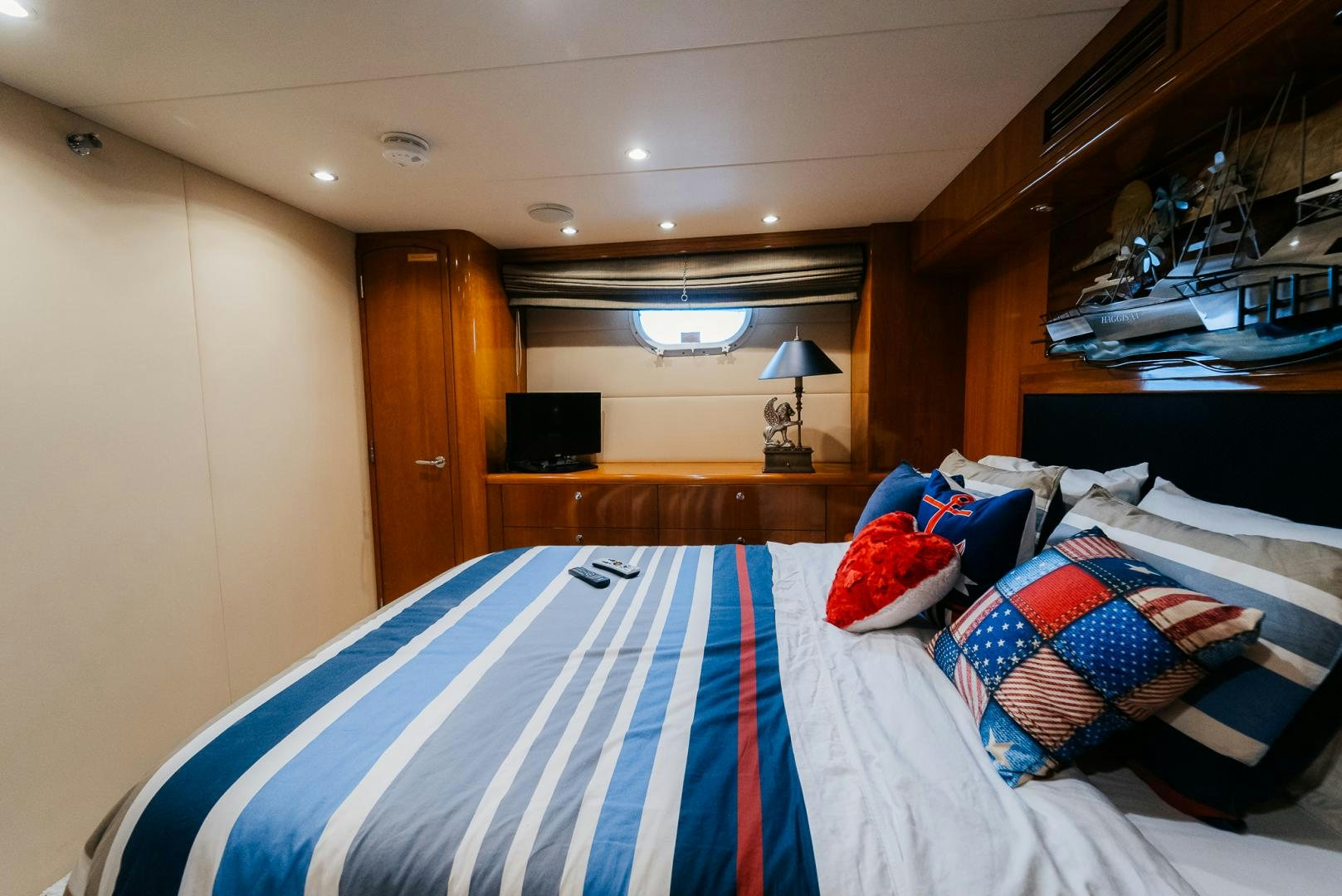 a bedroom with a bed and a desk aboard Haggis XV Yacht for Sale