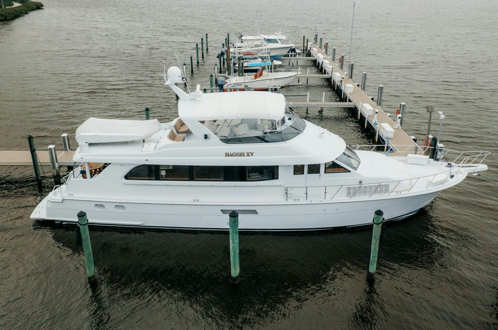 a white boat on a dock aboard Haggis XV Yacht for Sale