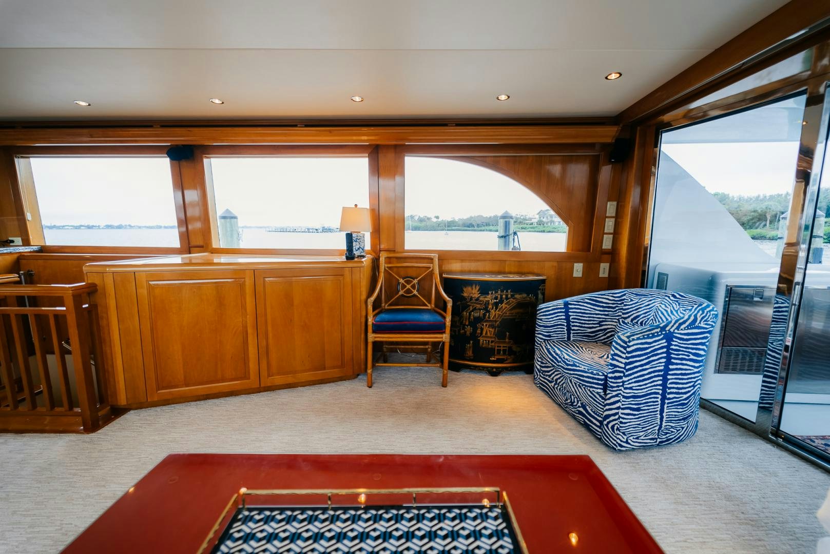a room with a red couch and a blue chair aboard Haggis XV Yacht for Sale