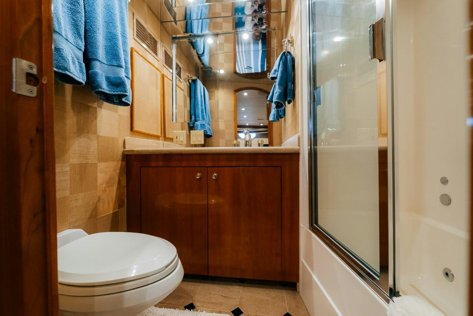 a bathroom with a toilet and a shower unit aboard Haggis XV Yacht for Sale
