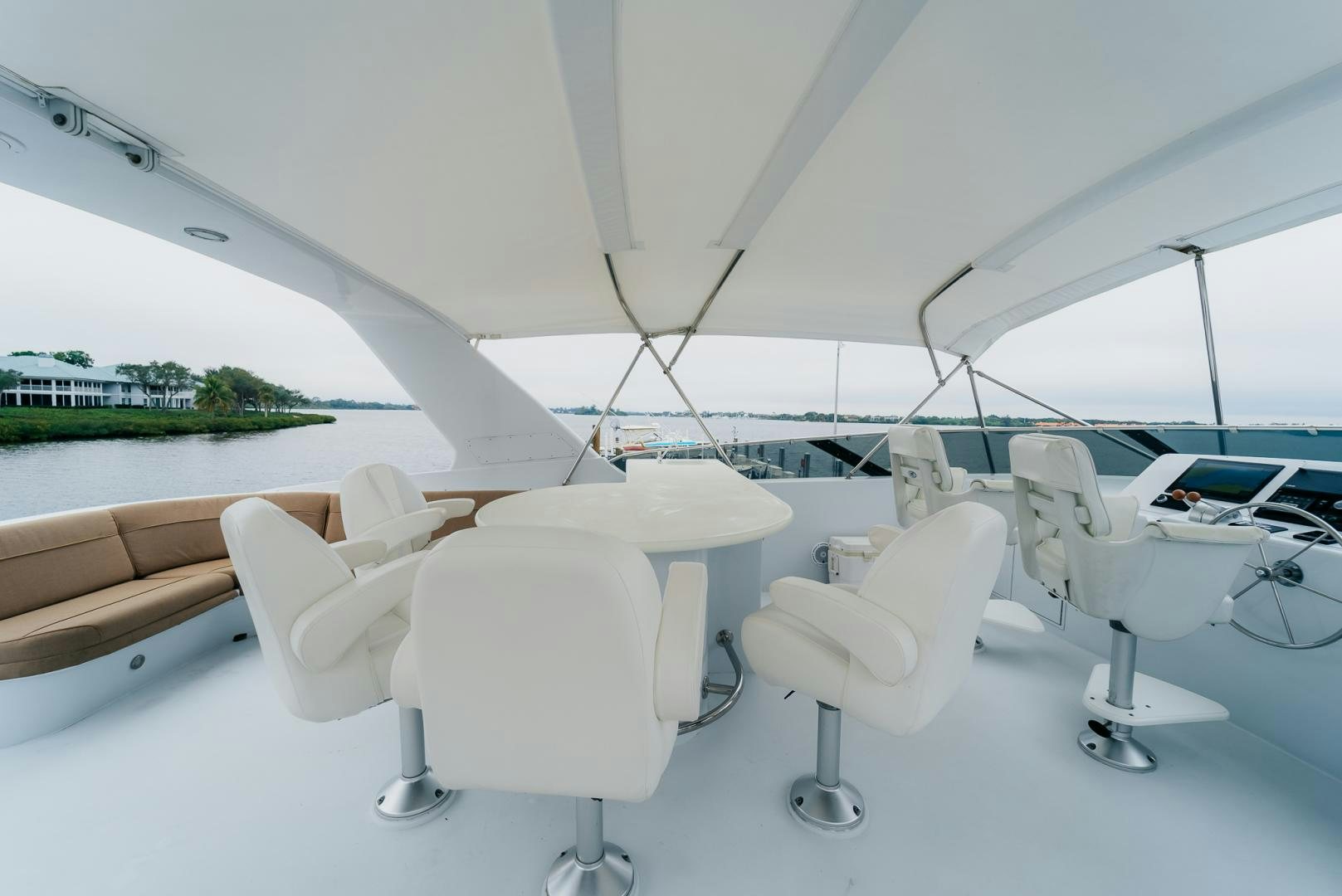 a group of white chairs in front of a window aboard Haggis XV Yacht for Sale