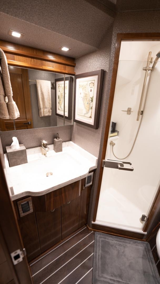 a bathroom with a sink and mirror aboard WHY WOULDN'T WE Yacht for Sale