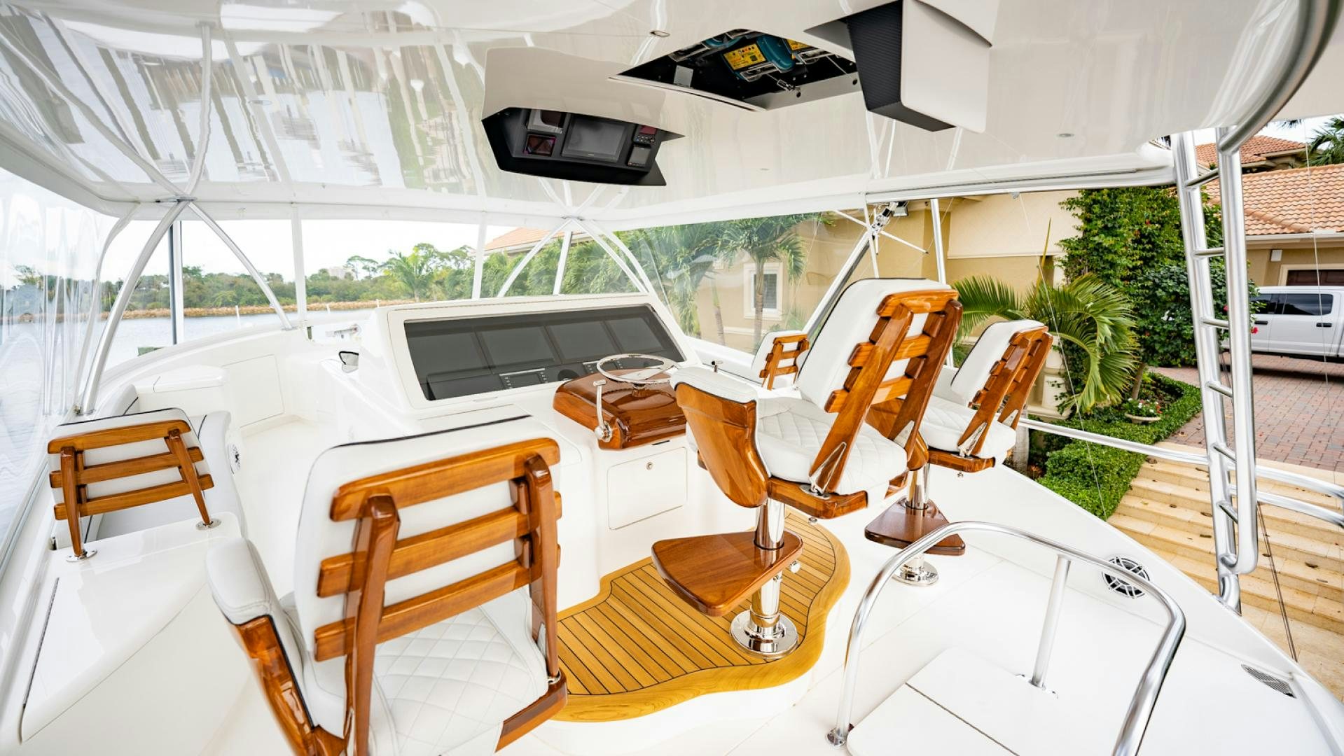 a large white tent with chairs and a table and a computer on it aboard WHY WOULDN'T WE Yacht for Sale