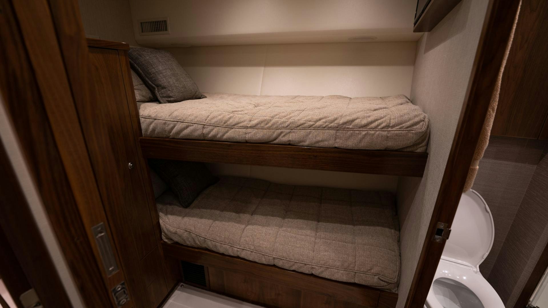 a bed with a wooden frame aboard WHY WOULDN'T WE Yacht for Sale