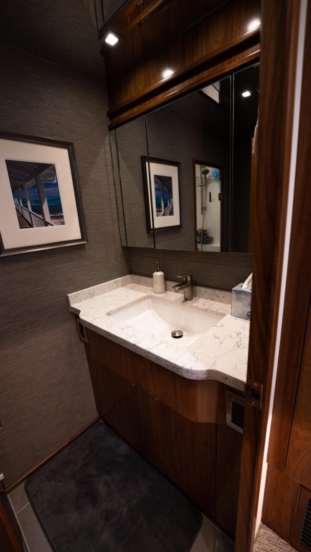 a bathroom with a sink and a mirror aboard WHY WOULDN'T WE Yacht for Sale
