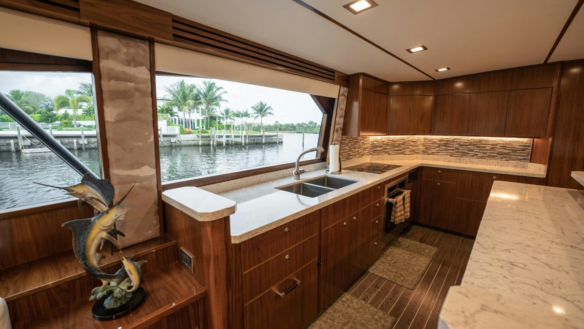a kitchen with wooden cabinets aboard WHY WOULDN'T WE Yacht for Sale