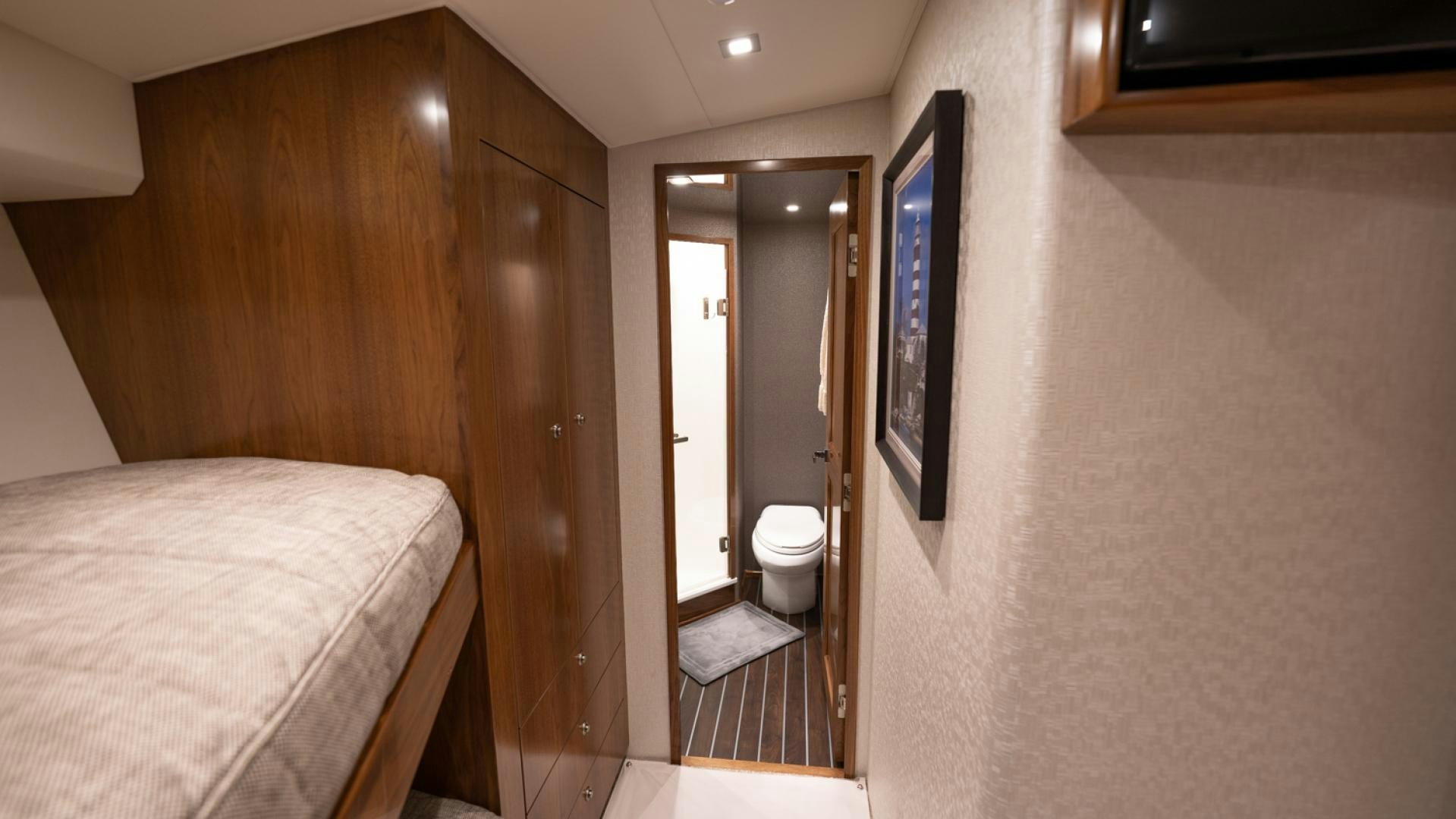 a bedroom with a bed and a mirror aboard WHY WOULDN'T WE Yacht for Sale
