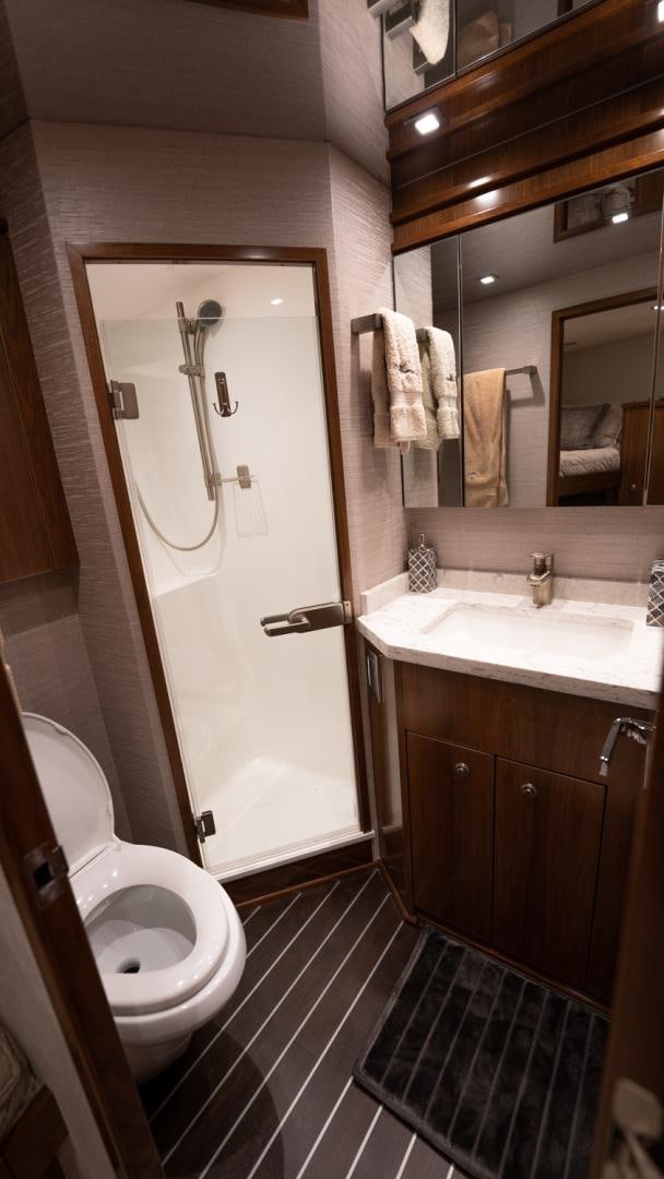 a bathroom with a toilet and sink aboard WHY WOULDN'T WE Yacht for Sale