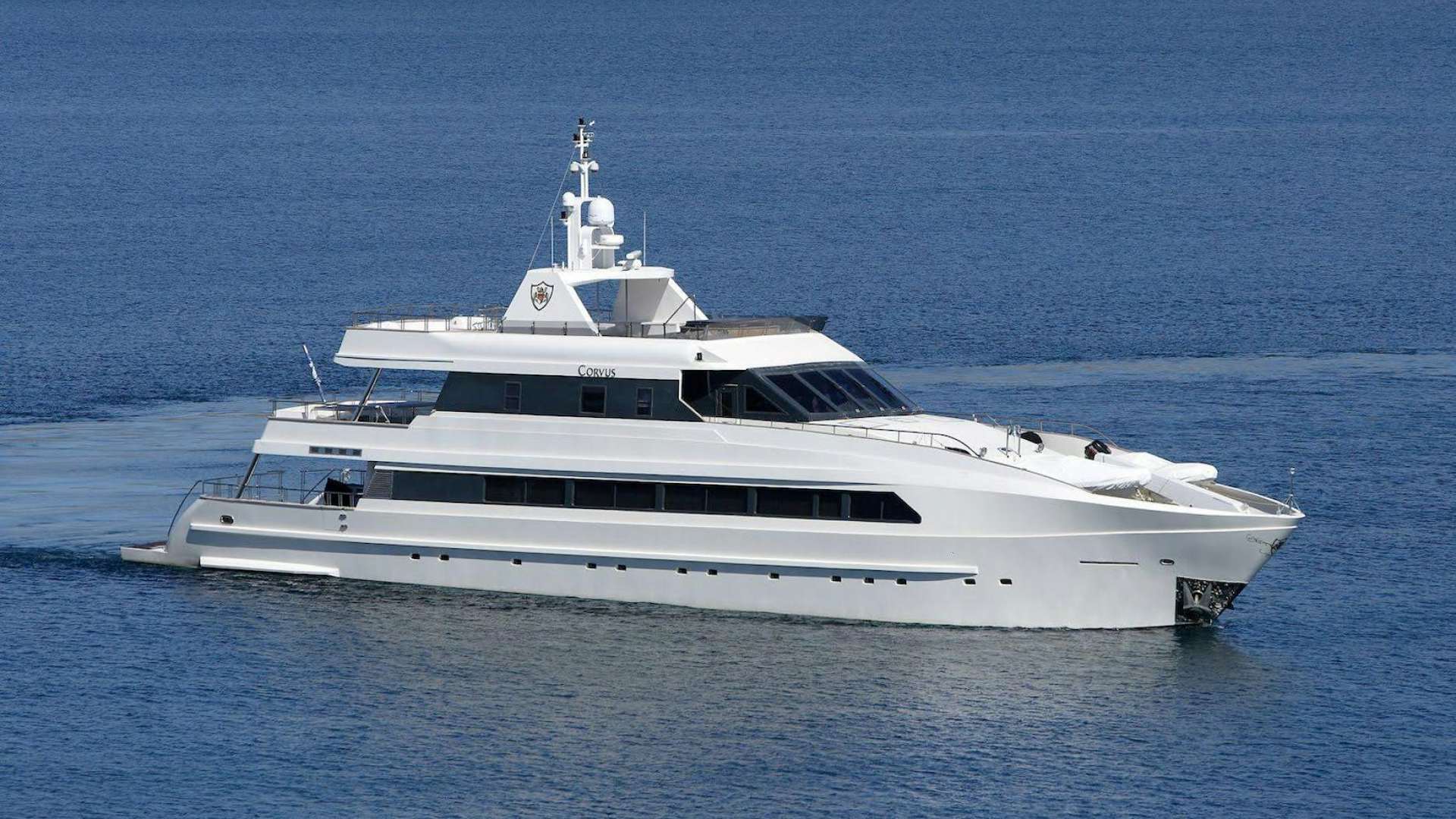 a white yacht in the water aboard Corvus Yacht for Sale