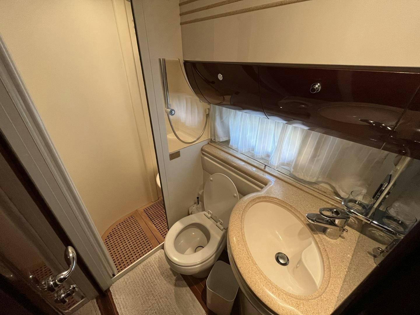 a bathroom with a sink toilet and a mirror aboard SELAH WAY Yacht for Sale
