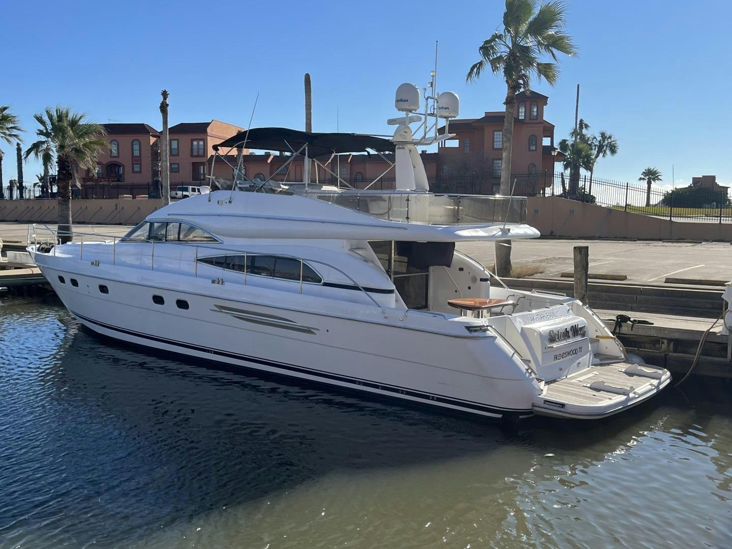 a white boat docked at a pier aboard SELAH WAY Yacht for Sale